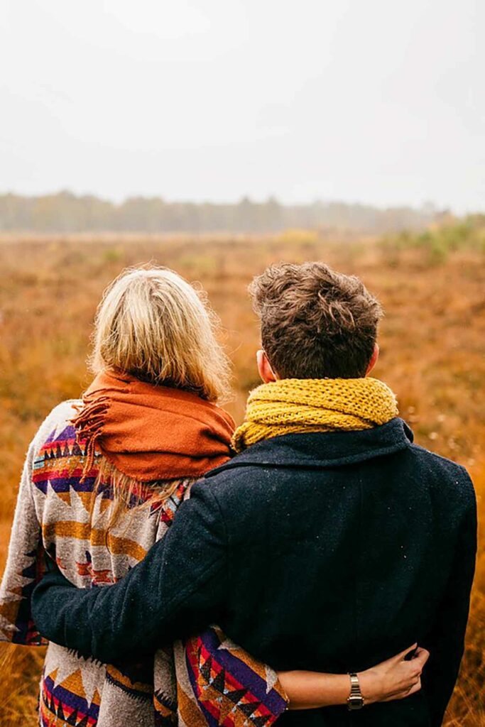 couple hugging in the middle of fields
