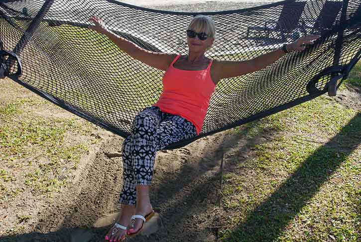 aging woman sitting on a hammock