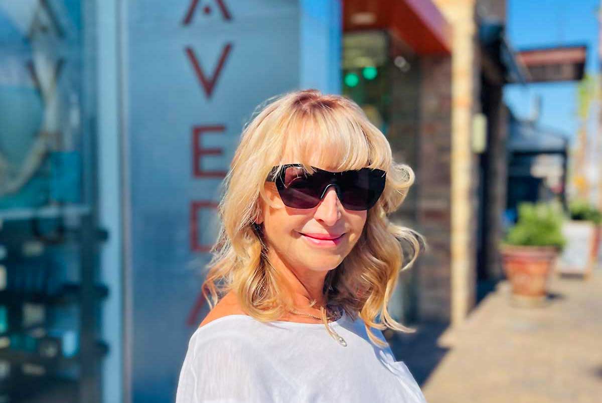 Mature woman in front of a hair salon after having her hair done