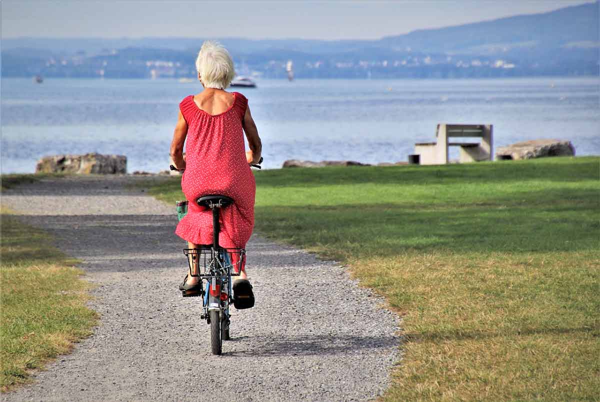 elderly woman cycling in a park