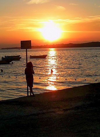 woman watching sunset and thinking